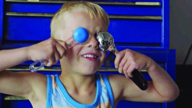 Child playing with spoons.