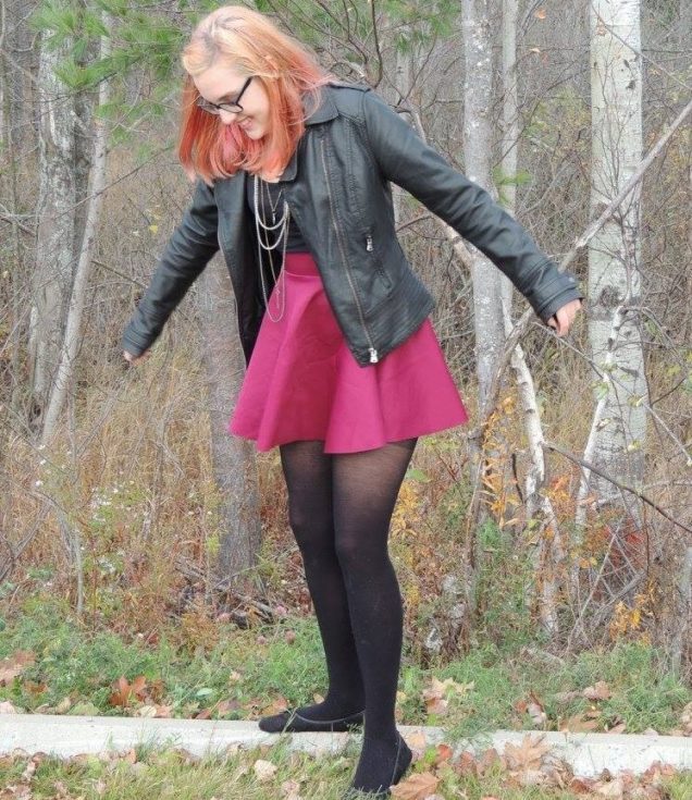Becca Schofield standing in front of some trees.
